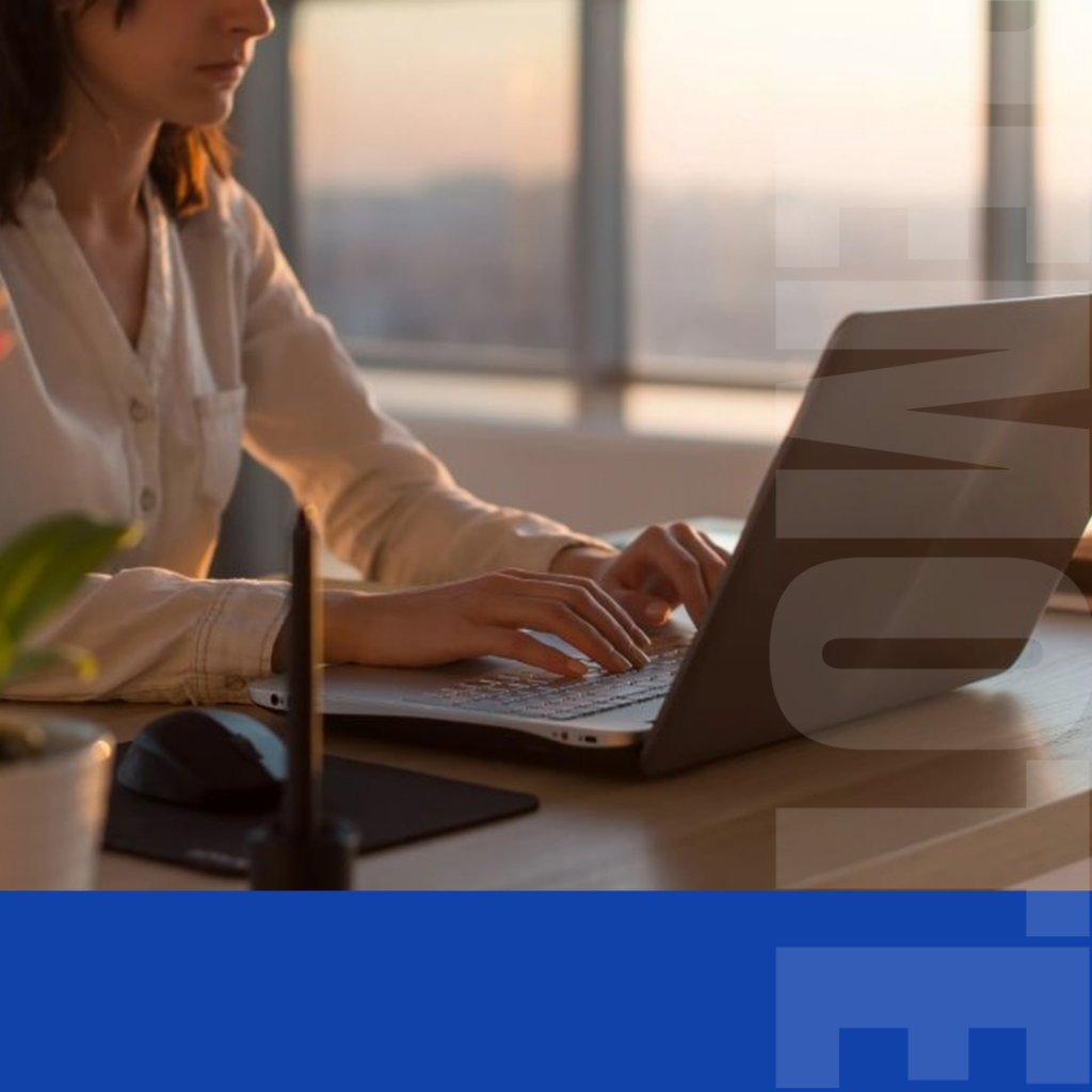 A woman is working on a computer remotely.